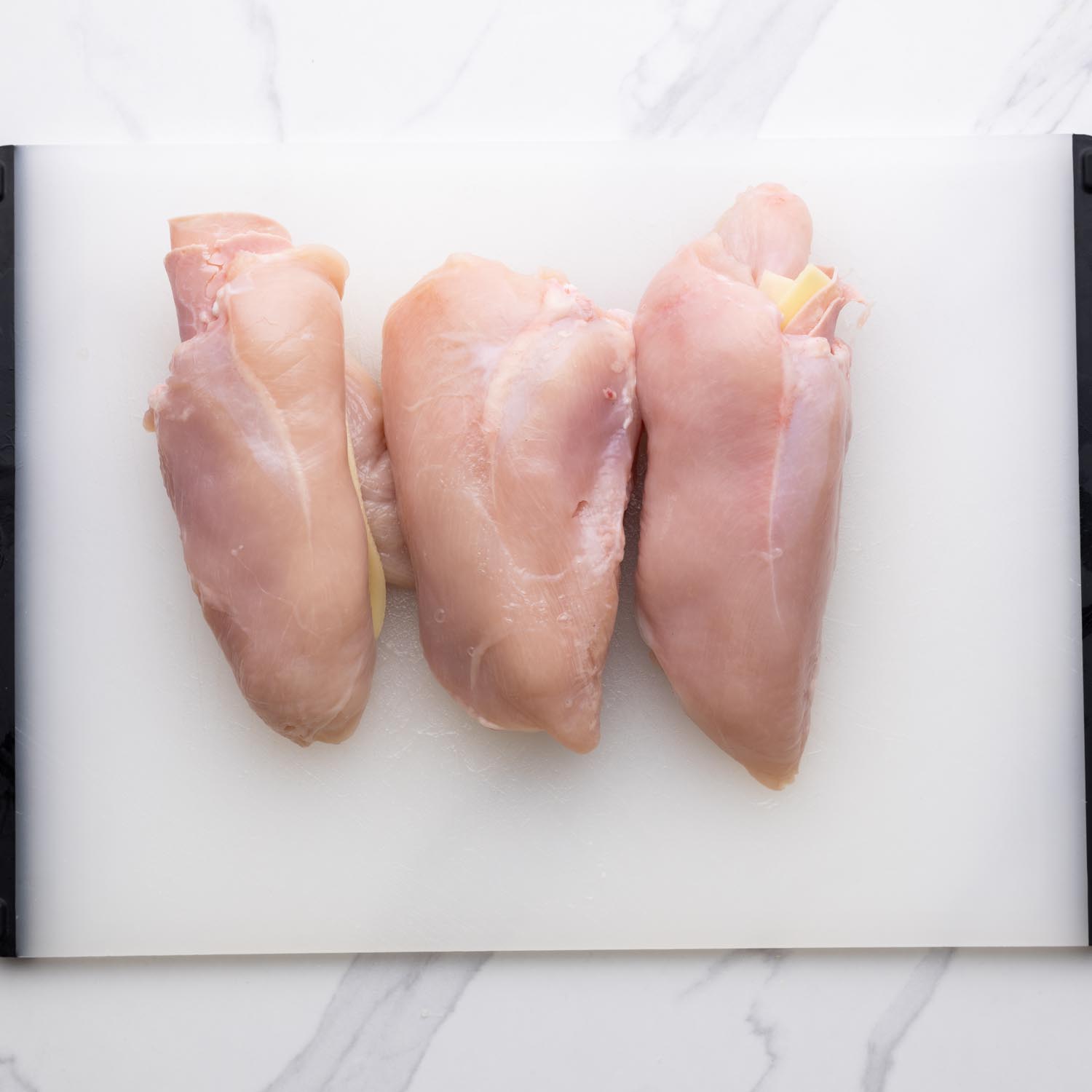 three chicken breasts stuffed with ham and cheese for cordon bleu