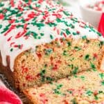 a loaf of Christmas Bread slided to show the red and green sprinkles inside.