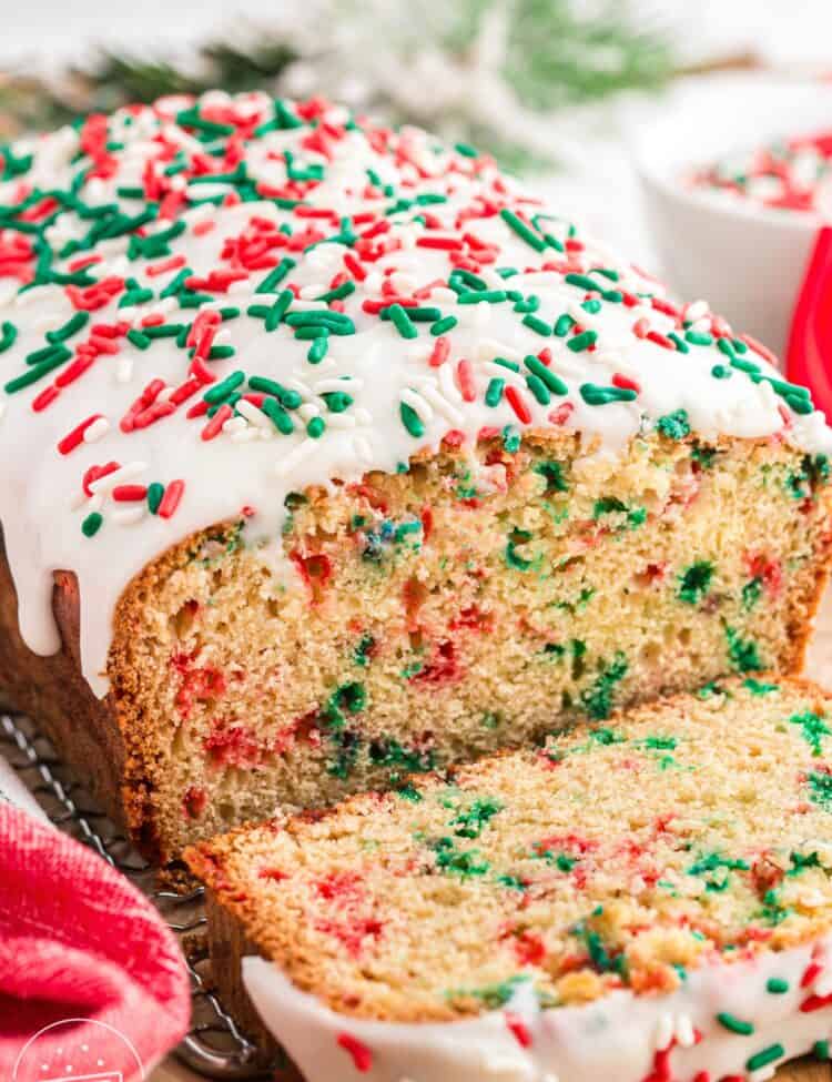 a loaf of Christmas Bread slided to show the red and green sprinkles inside.