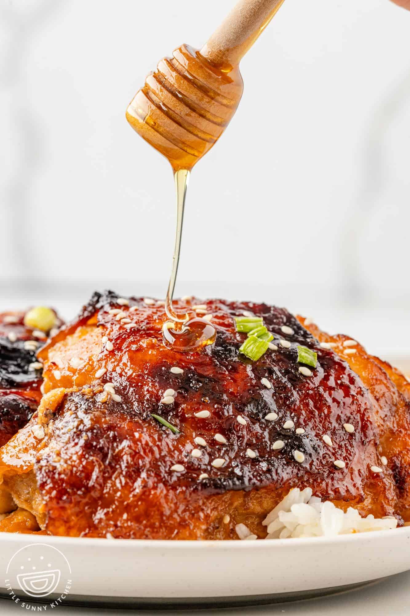 honey drizzled over cooked chicken thighs.