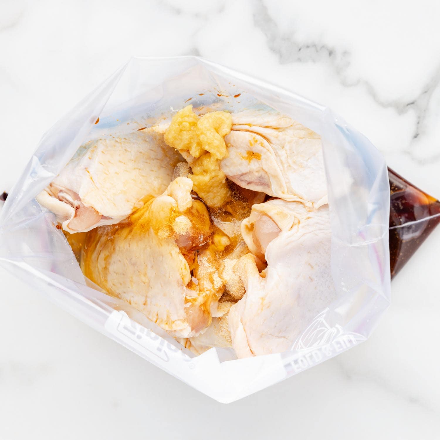 chicken thighs and honey soy marinade in a plastic ziplock bag.