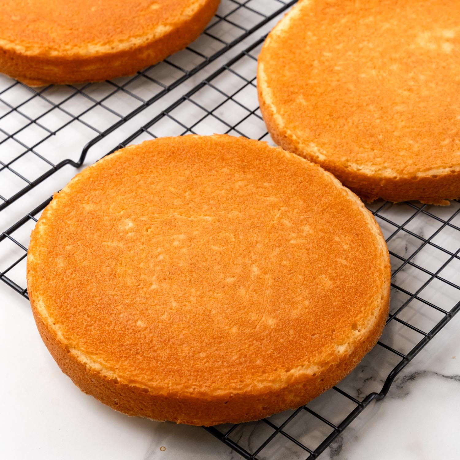 cake layers cooling on a wire rack.