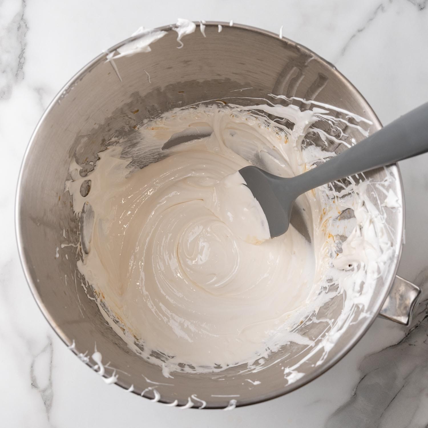 7 minute frosting in a metal mixing bowl.