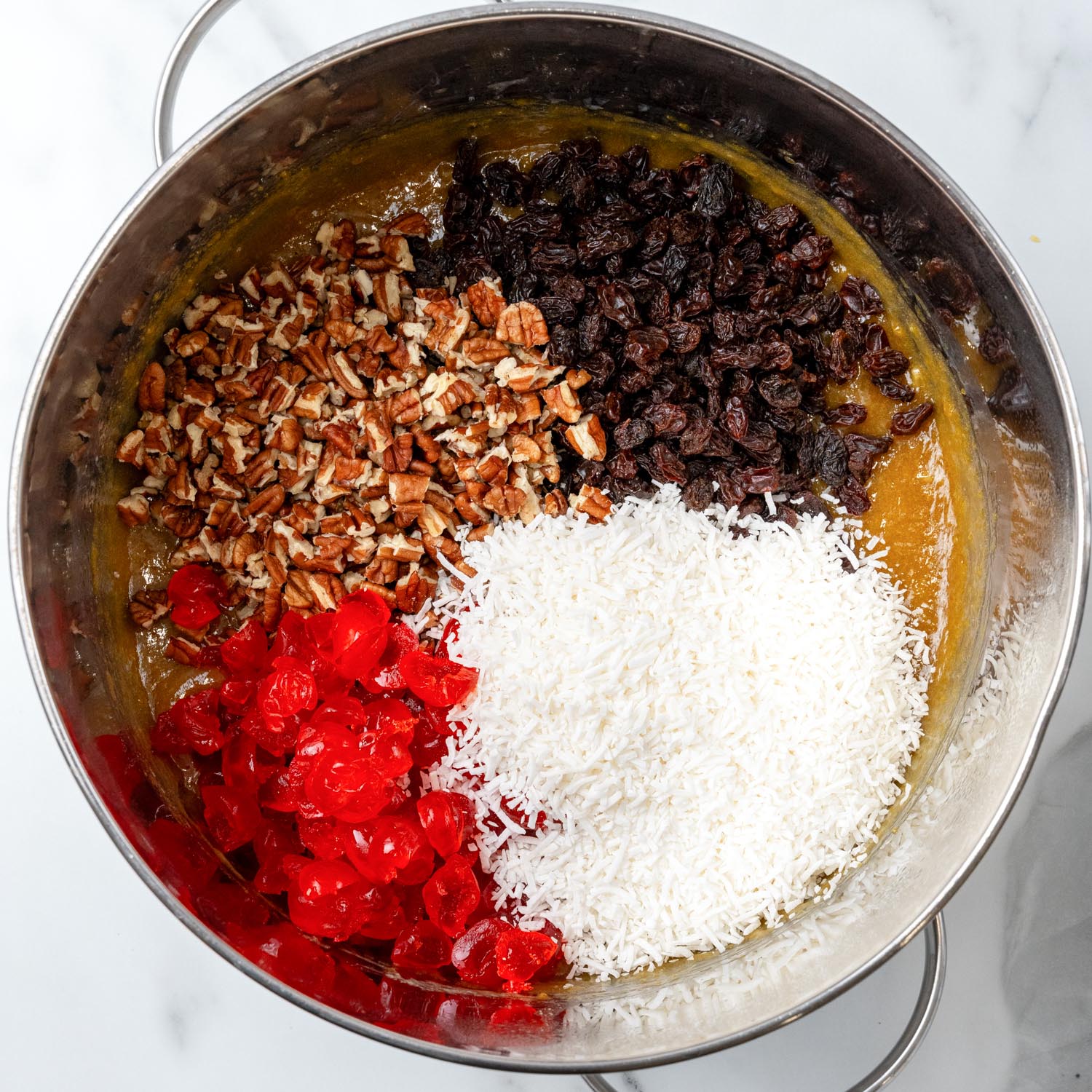 candied cherries, chopped pecans, raisins, and coconut shreds added to caramel to make lane cake filling