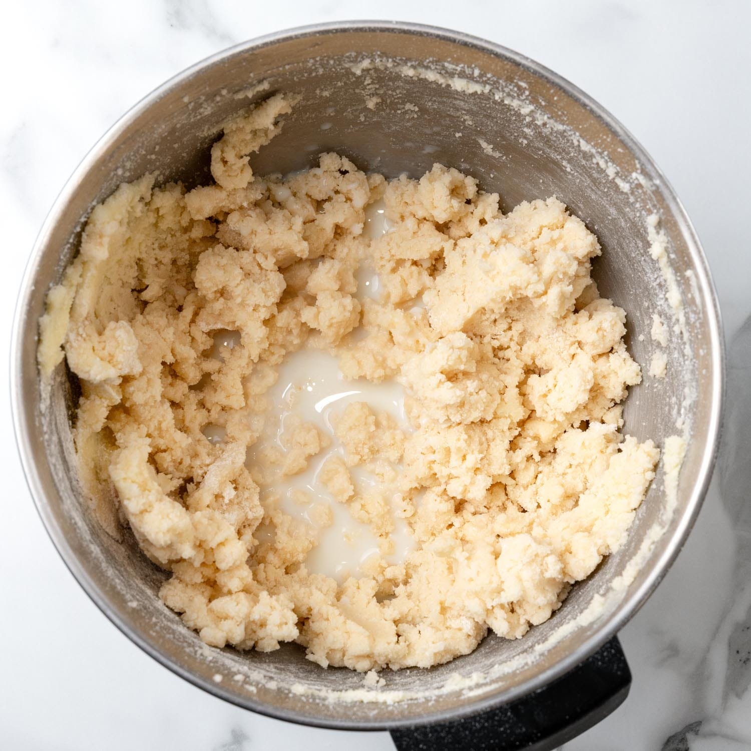 milk added to a mixing bowl for lane cake batter.