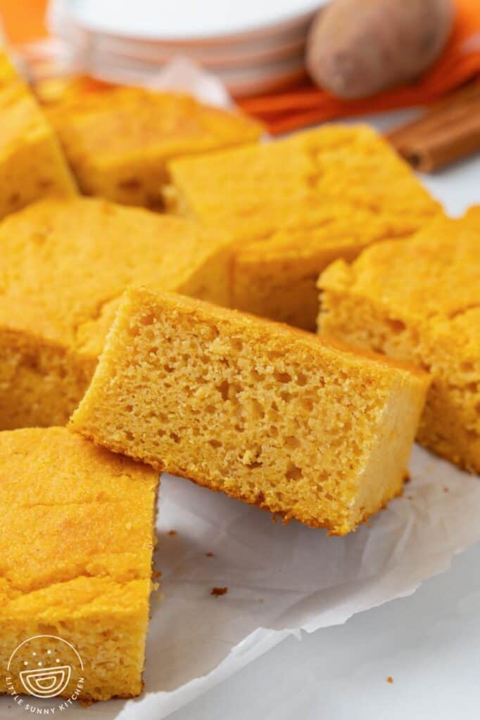 closeup of pieces of sweet potato cornbread. Image shows the light, springym moist crumb.