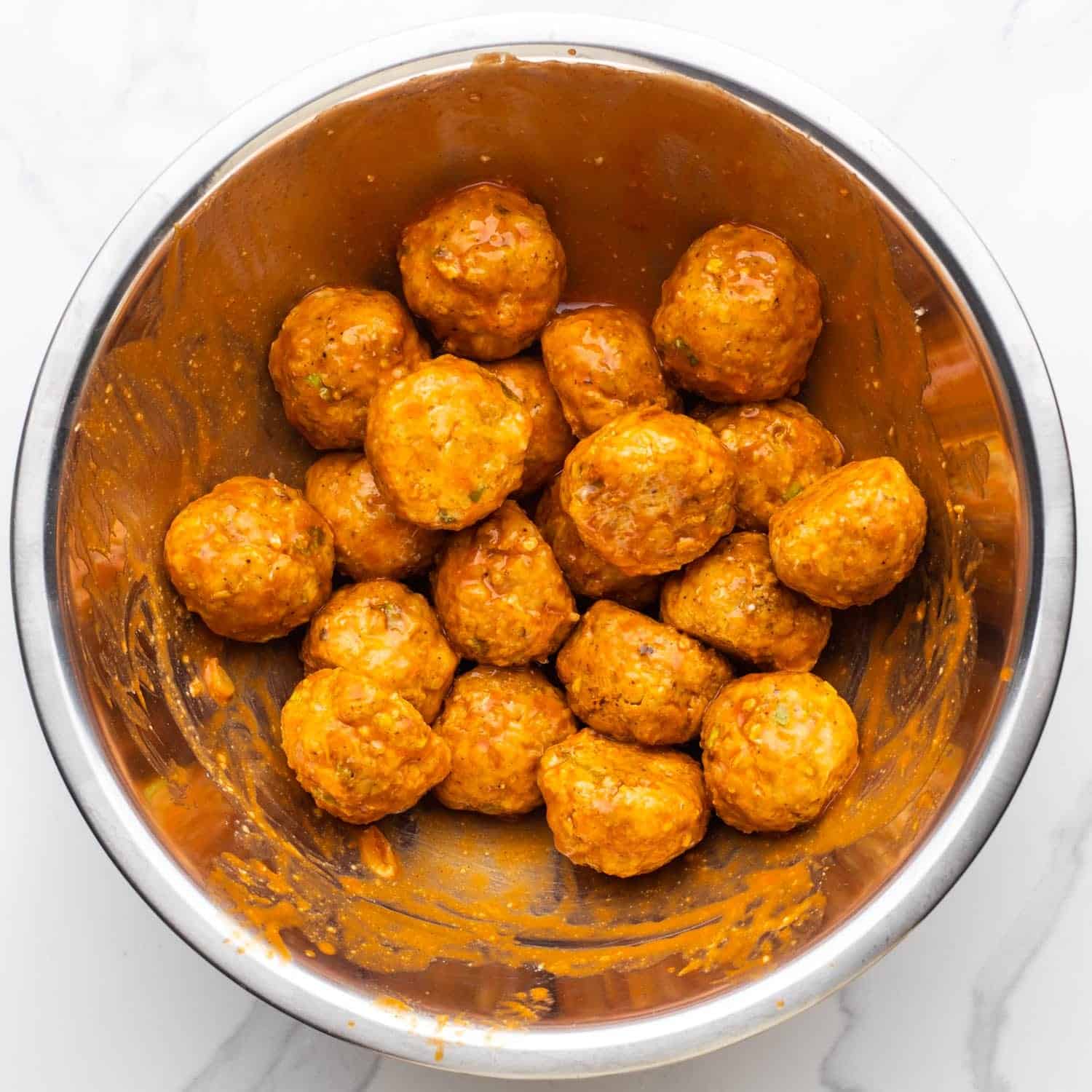 saucy buffalo chicken meatballs in a metal bowl.