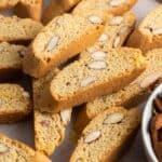 baked crispy cantucci biscotti on a parchment lined surface.