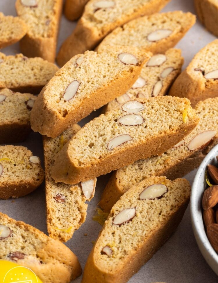 baked crispy cantucci biscotti on a parchment lined surface.