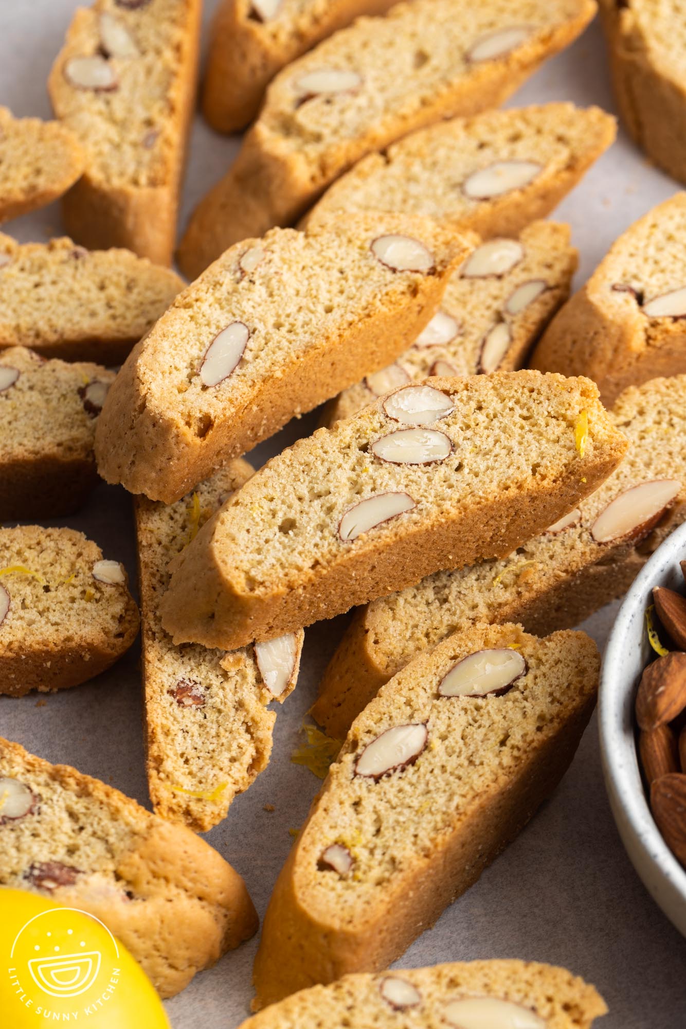 baked crispy cantucci biscotti on a parchment lined surface.