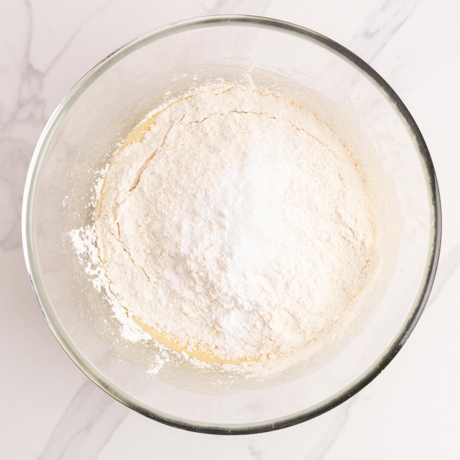 flour added to a mixing bowl for cantucci dough.