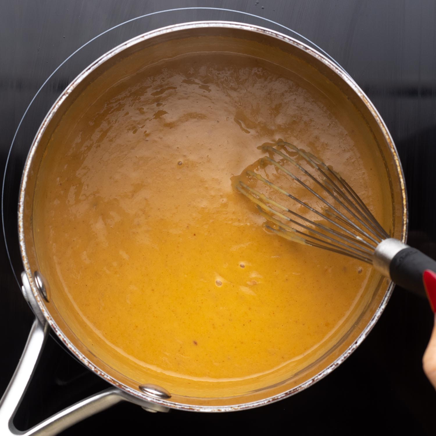 peanut sauce for chicken satay cooking in a saucepan.