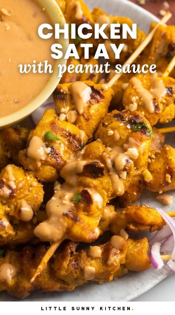 a plate of chicken skewers with a bowl of peanut sauce. Text overlay says "chicken satay with peanut sauce"