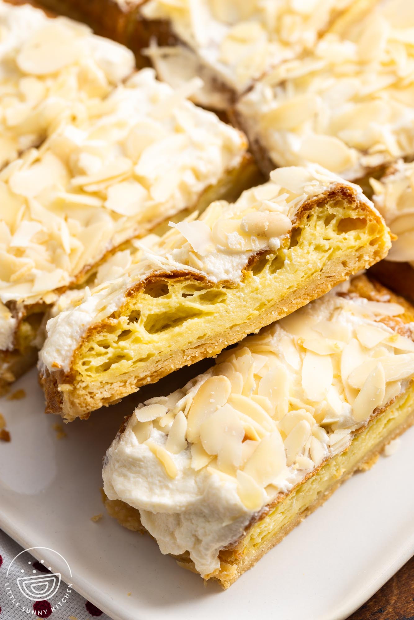 sliced almond danish puff pastry on a platter.