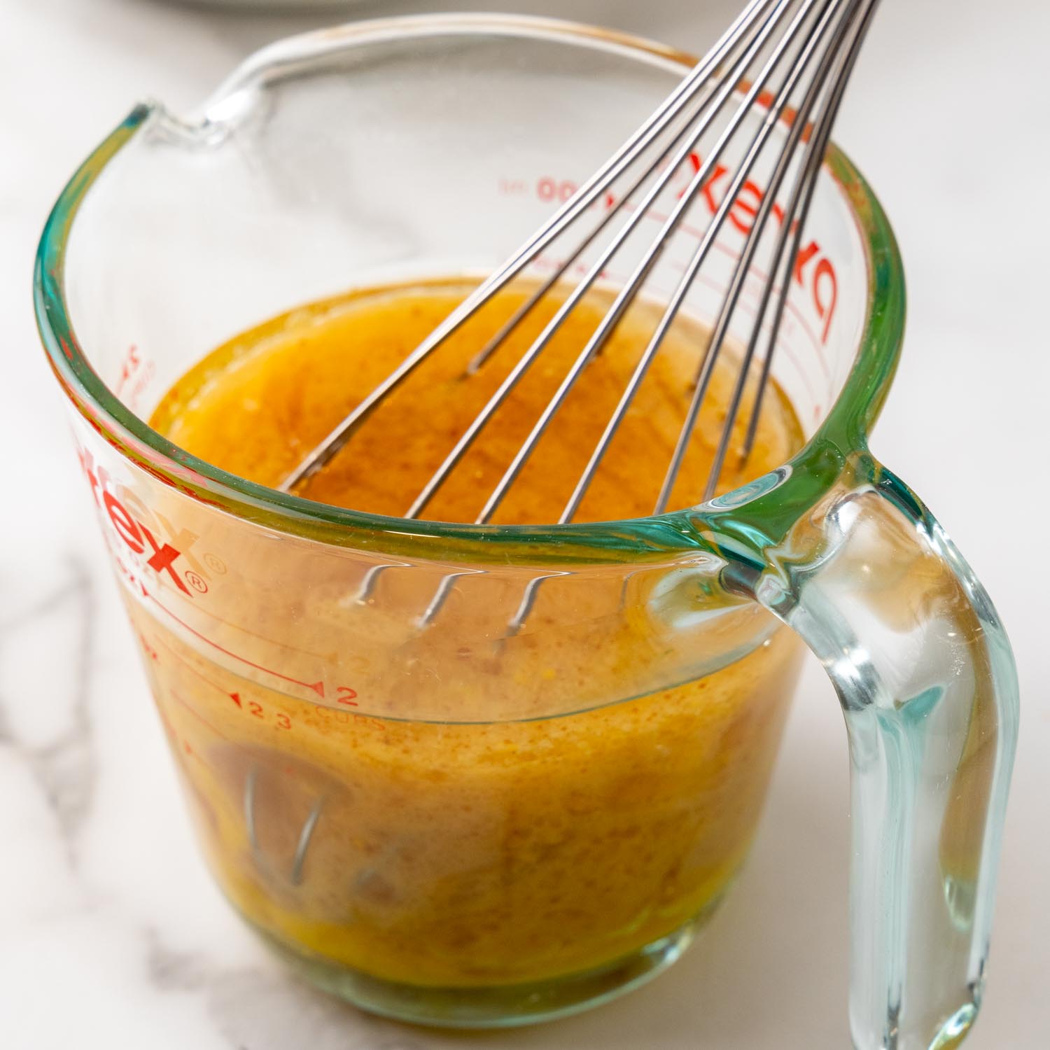 oil and eggs whisked together in a measuring cup.