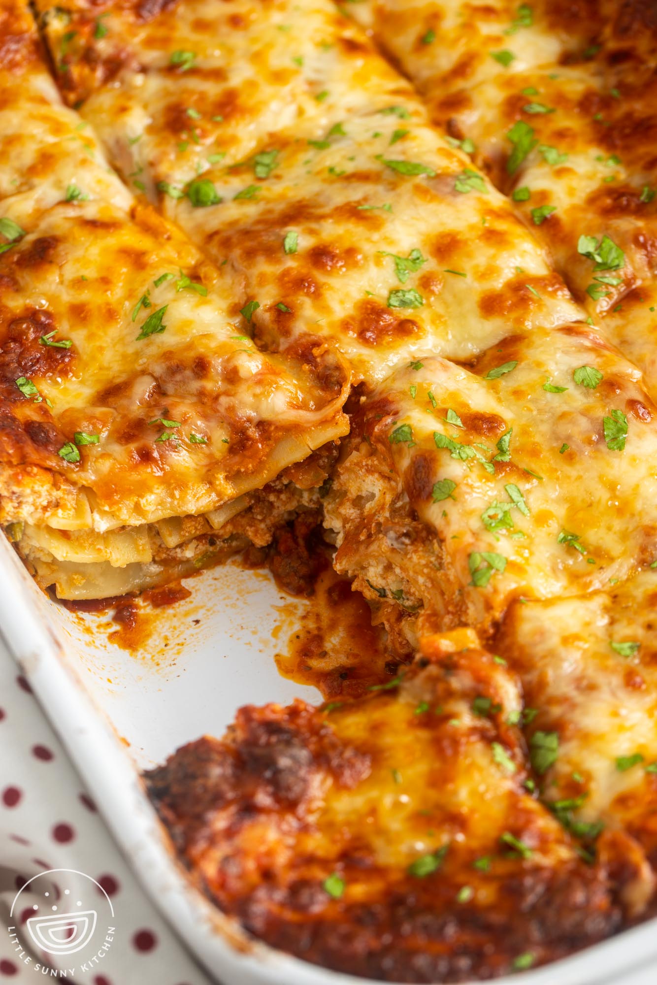 a pan of lasagna missing one piece.