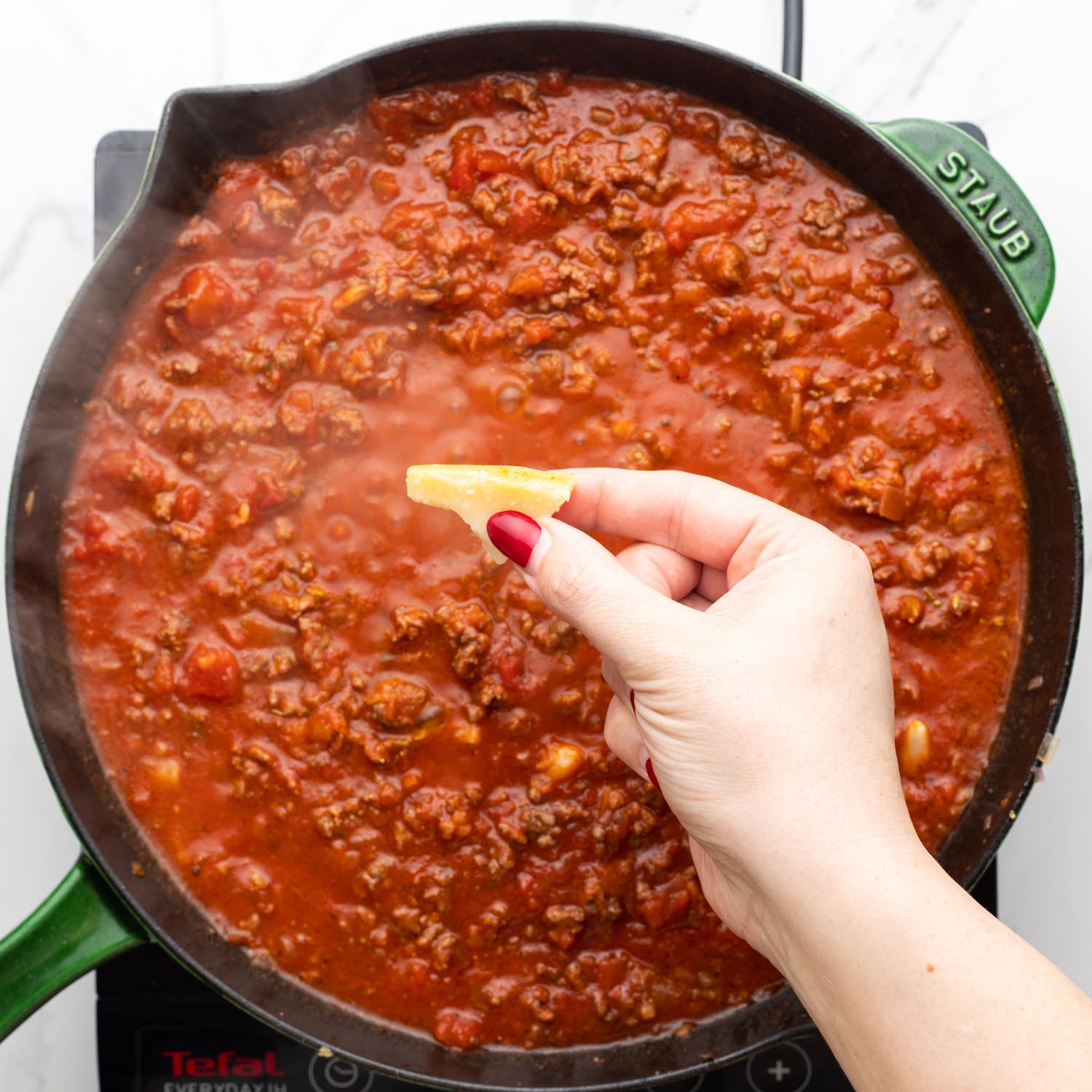 rind from parmesan added to meat sauce.