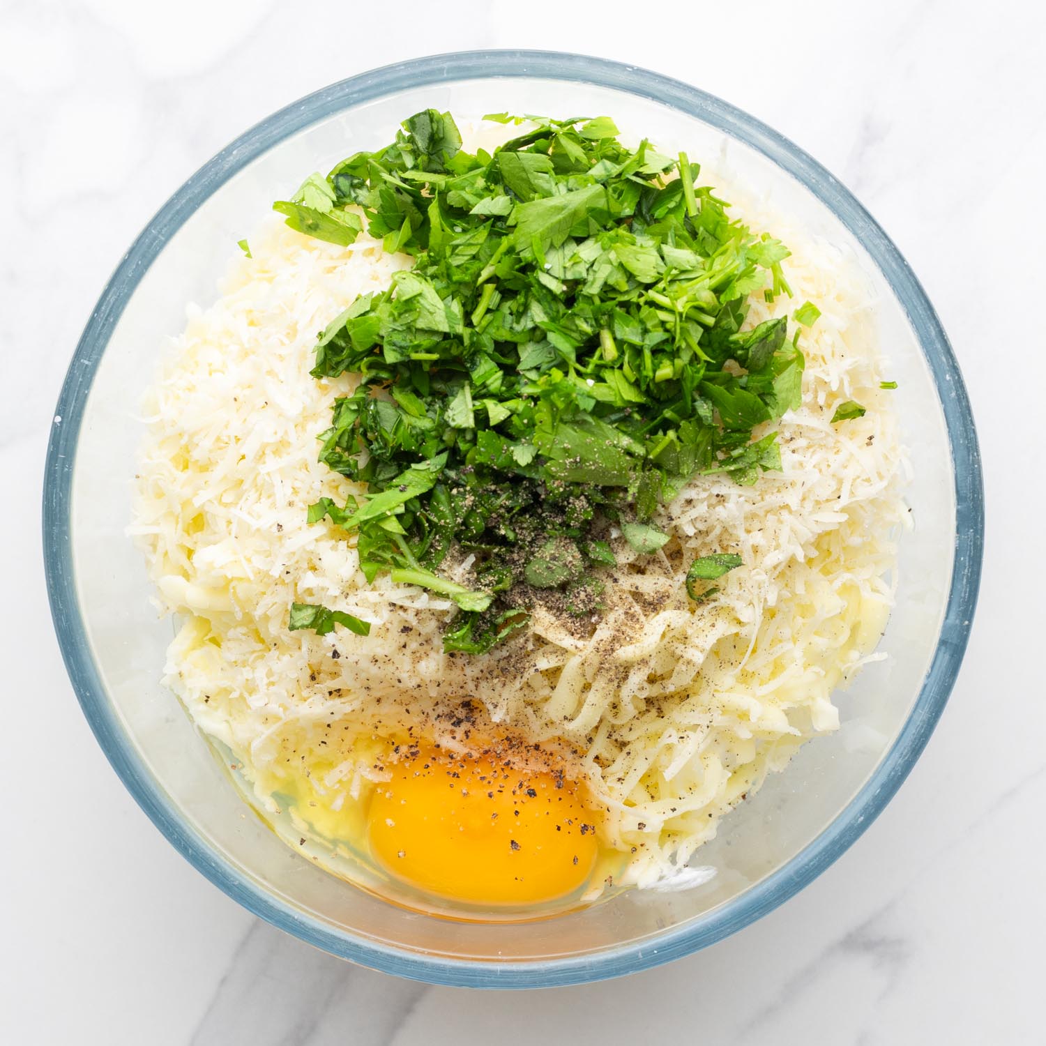 ricotta, mozzarella, egg, and parsley in a small glass bowl.