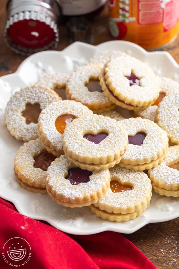 a platter of sandwich linzer cookies dusted with powdered sugar.