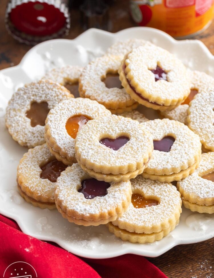 a platter of sandwich linzer cookies dusted with powdered sugar.