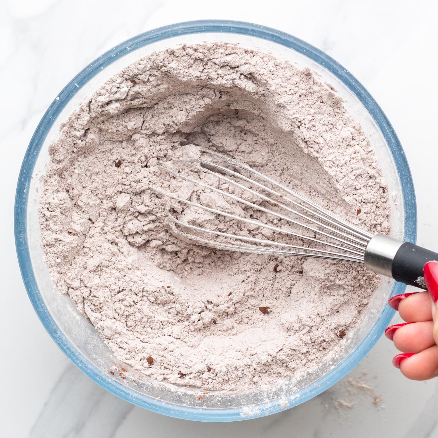 flour and cocoa powder whisked together in a glass bowl.