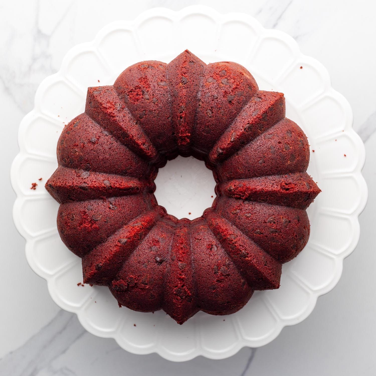 baked red velvet bundt cake, removed from the pan and placed on a platter.