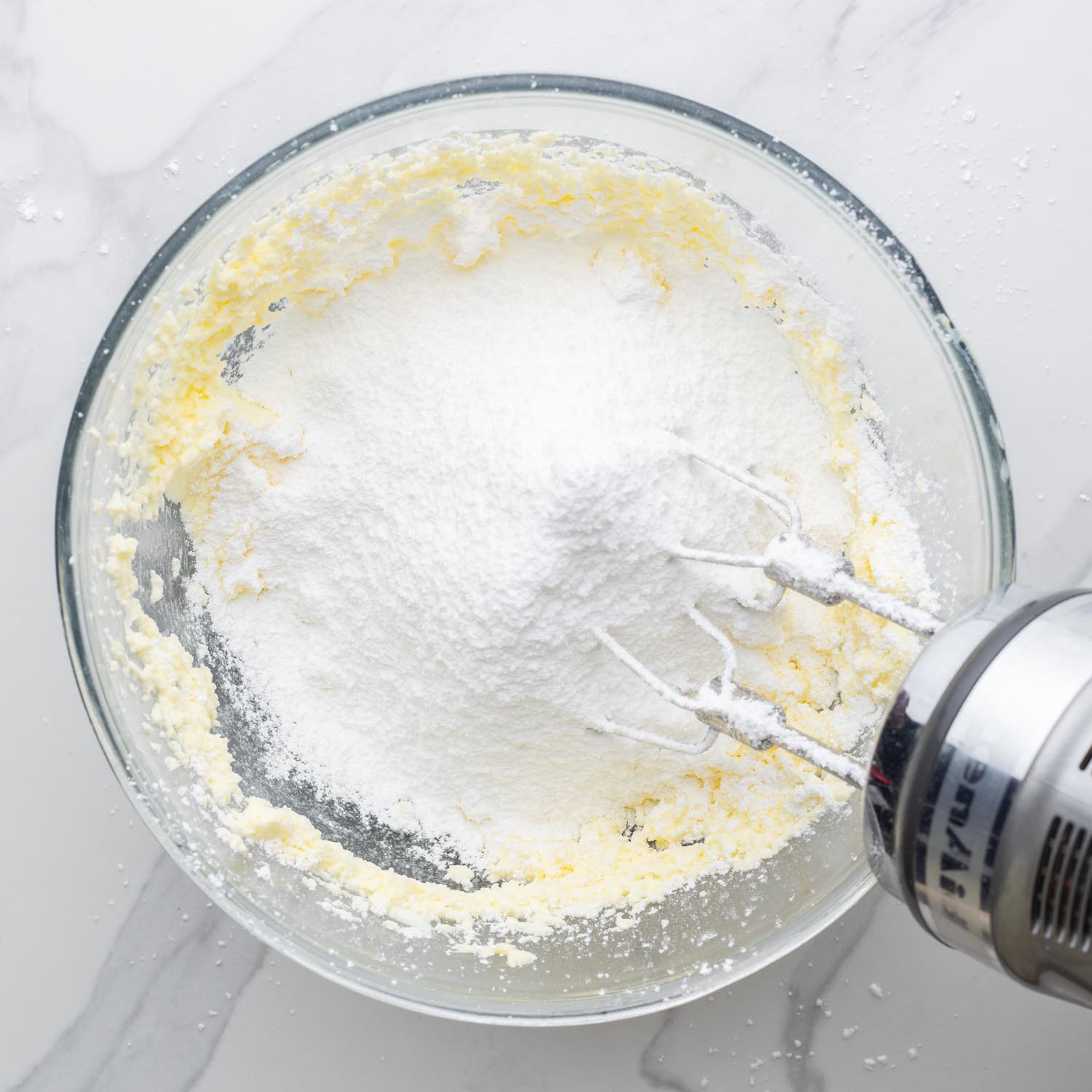 powdered sugar added to butter and mixed with an electric mixer.