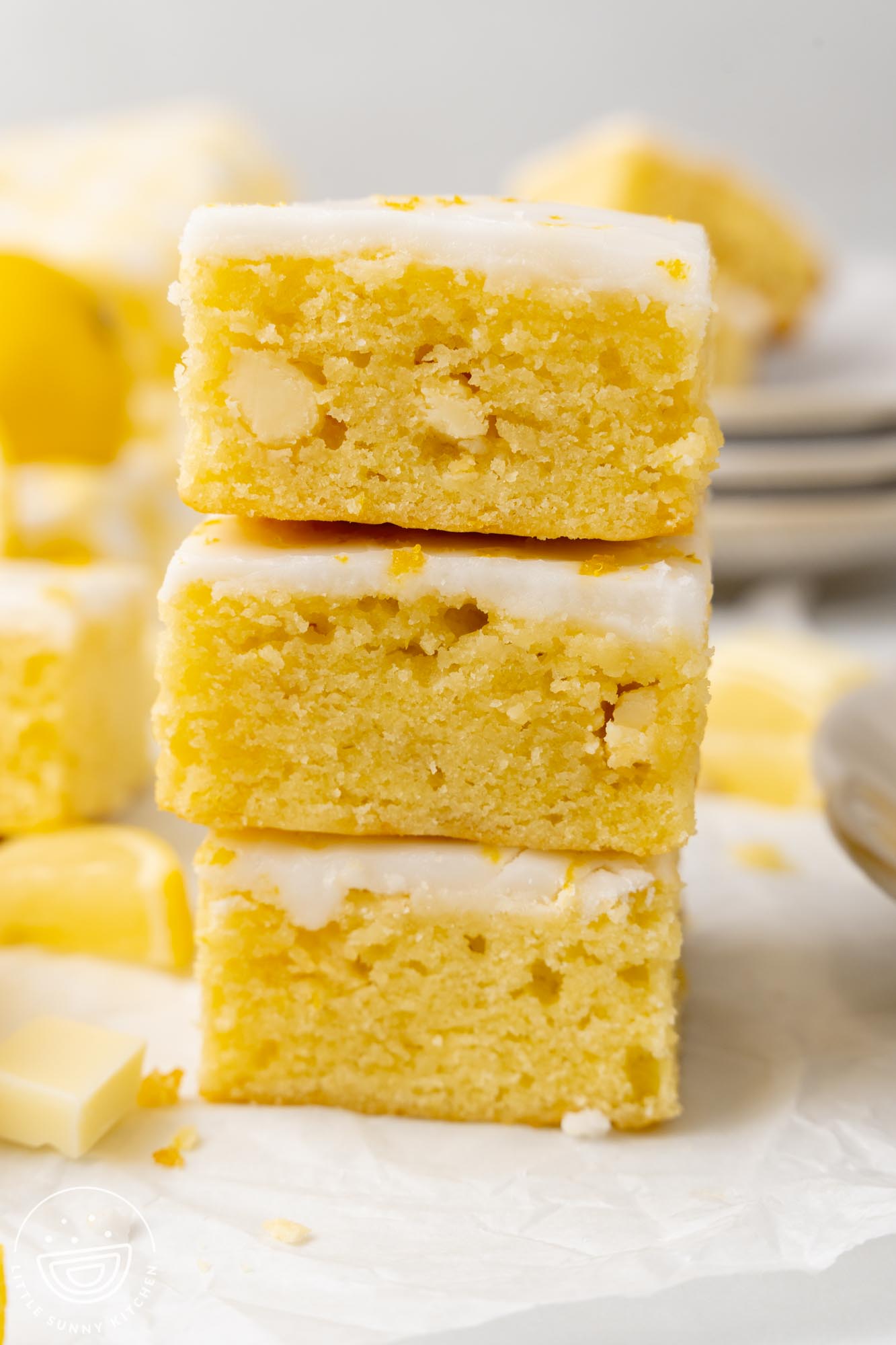 Three lemon brownie squares, stacked tall.