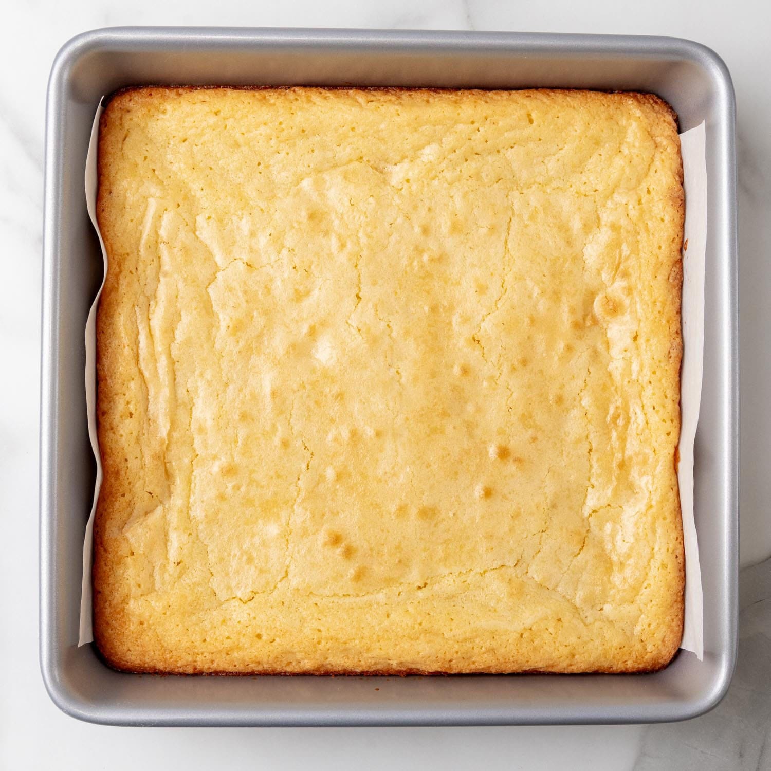 baked lemon brownies in a square baking pan.