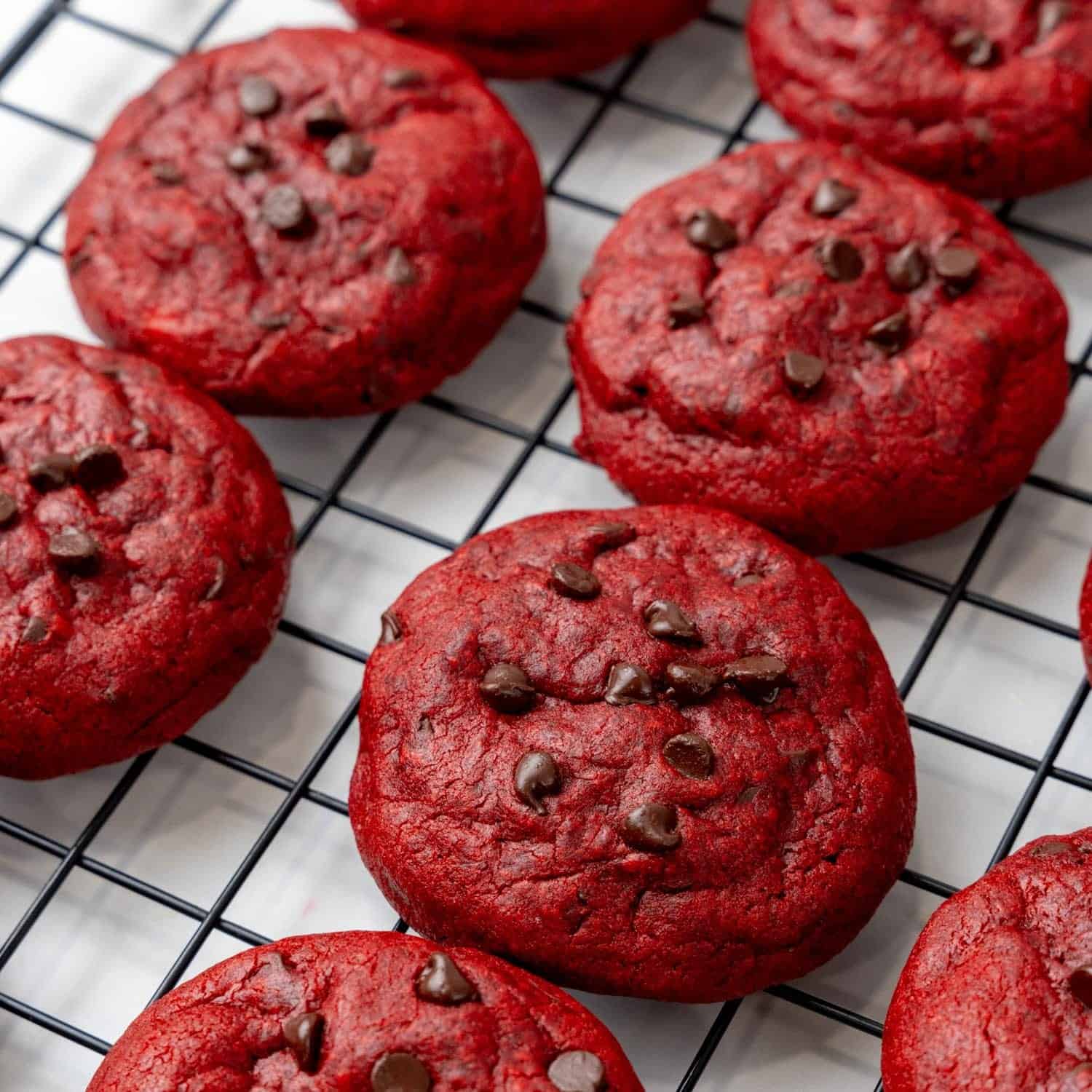 red velvet cream cheese cookies cooling on a wire rack.