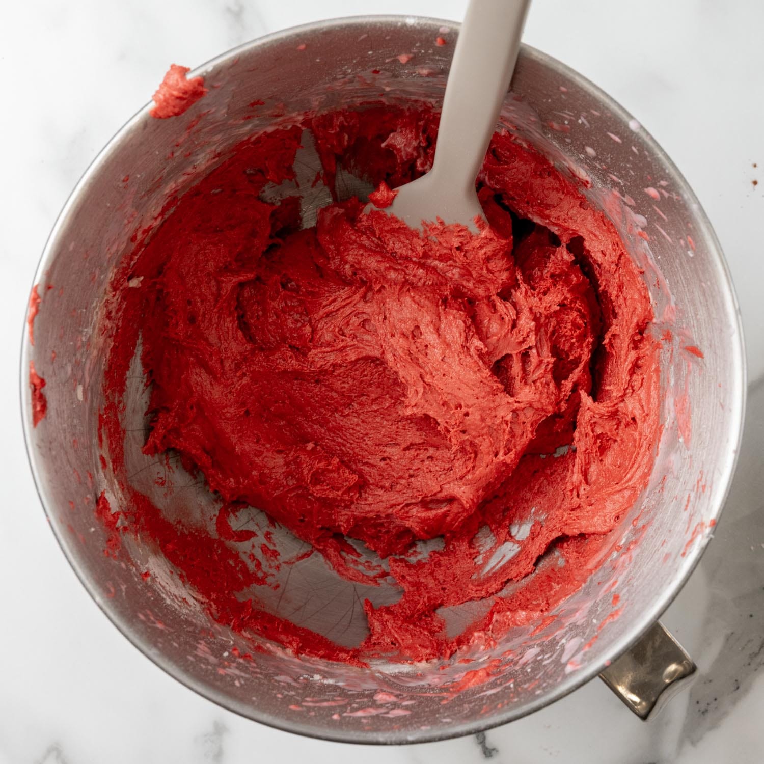 deep red batter for red velvet whoopie pies in a metal mixing bowl