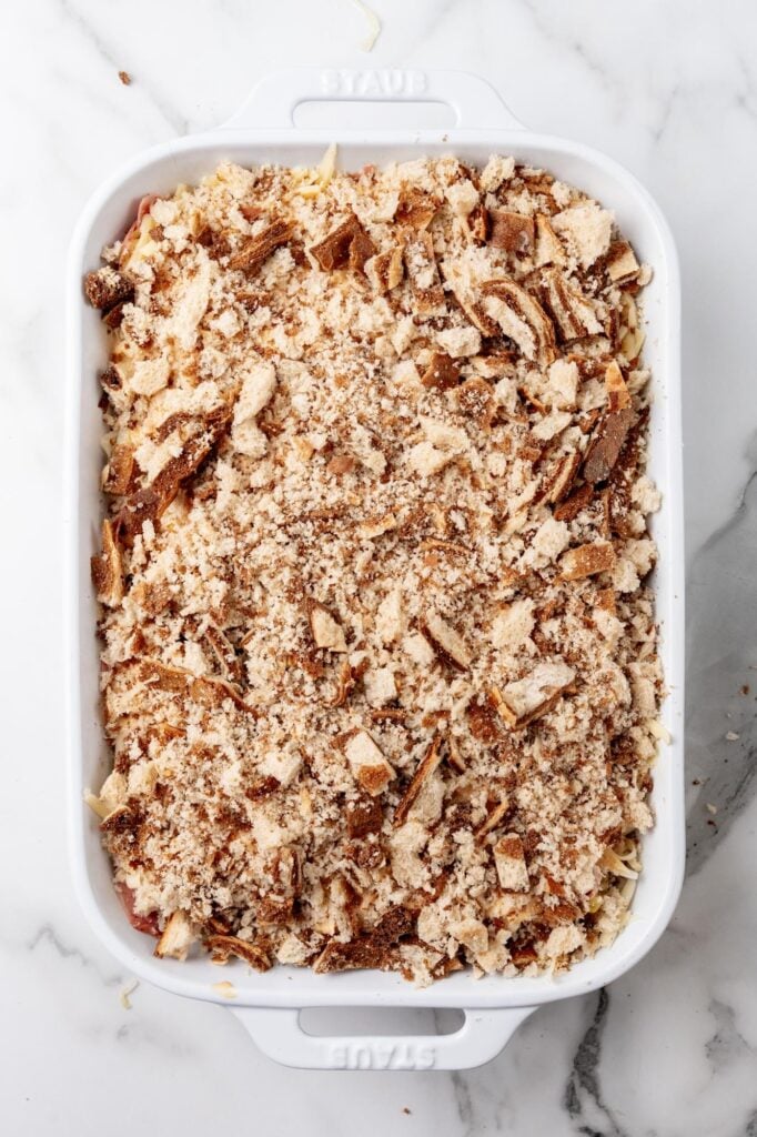 Reuben casserole in a rectangle pan, topped with marble rye bread crumbs.