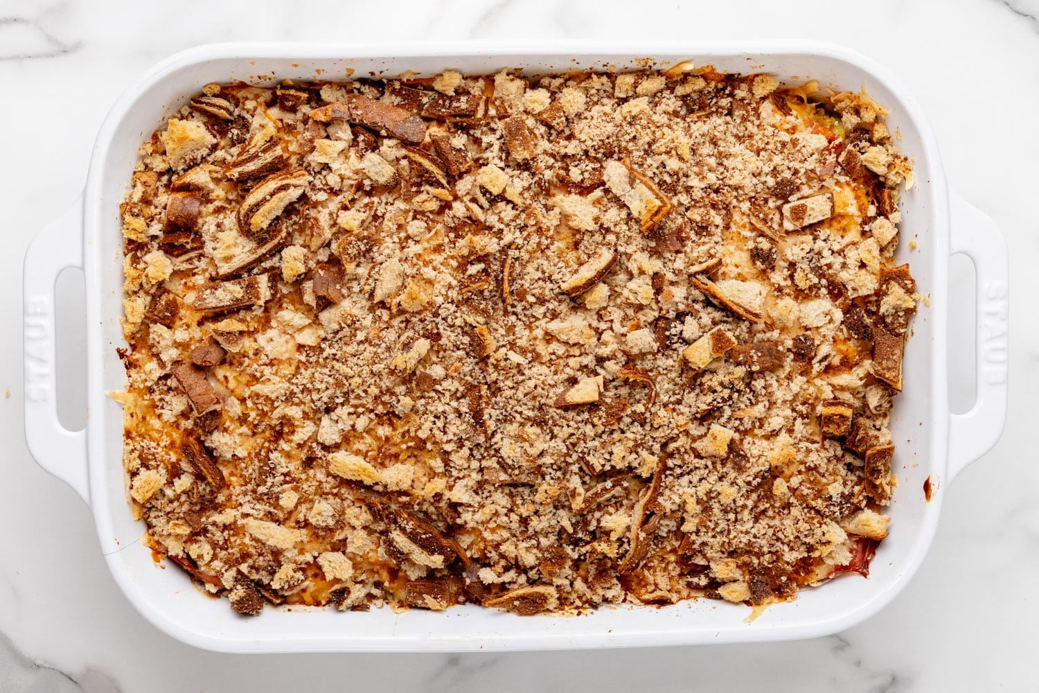 Browned, bake Reuben casserole in a pan, topped with rye bread crumbs.