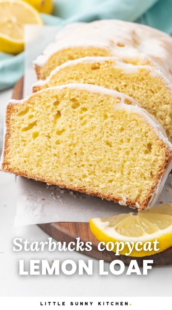 Close-up of a sliced Starbucks copycat lemon loaf with a white glaze, displayed on a wooden board with a lemon wedge and teal cloth in the background. Text overlay reads "Starbucks copycat LEMON LOAF".