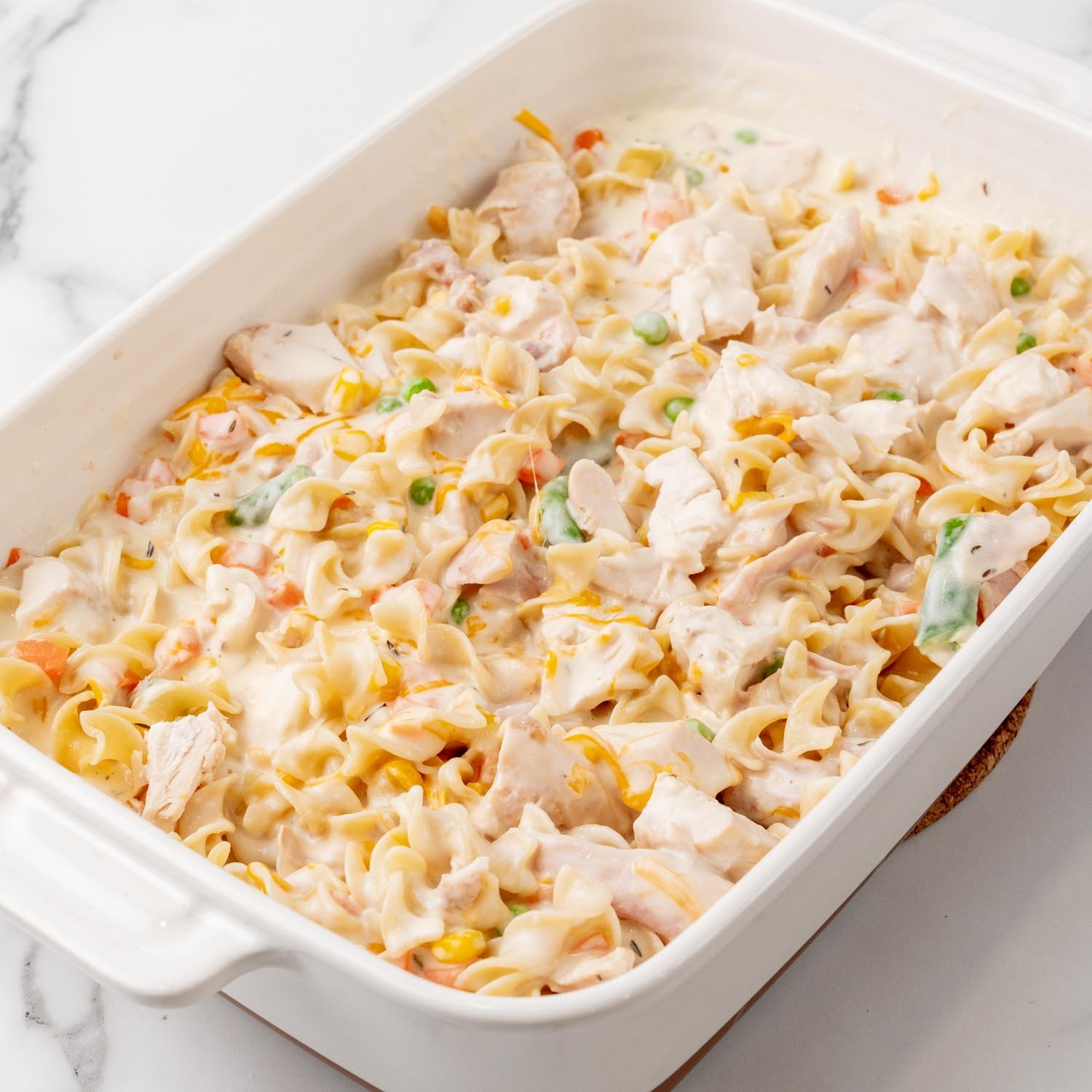 creamy chicken noodle casserole in a baking dish, before baking.