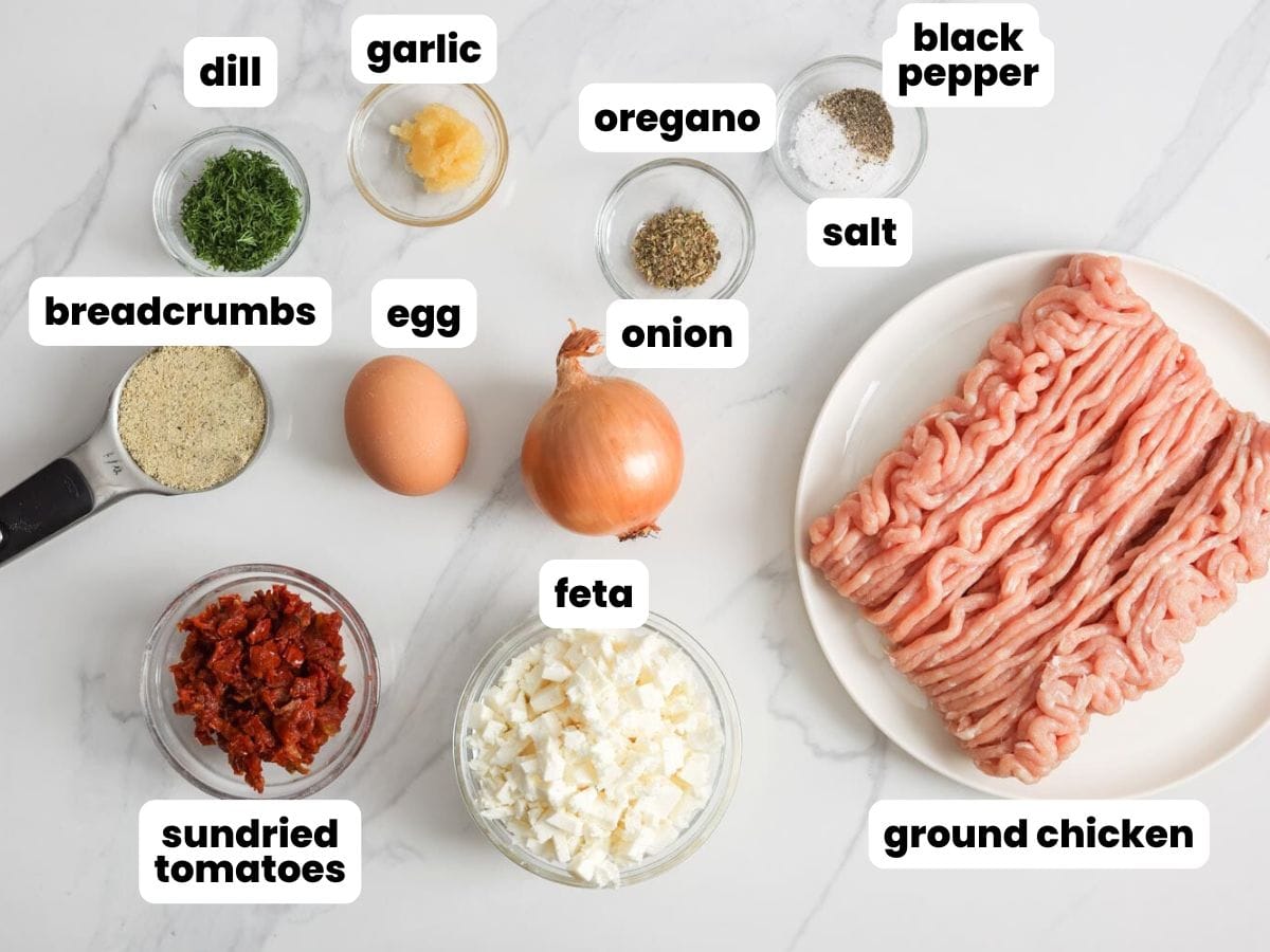 Ingredients needed to make greek style chicken burgers with feta, sundried tomatoes, garlic and dill.