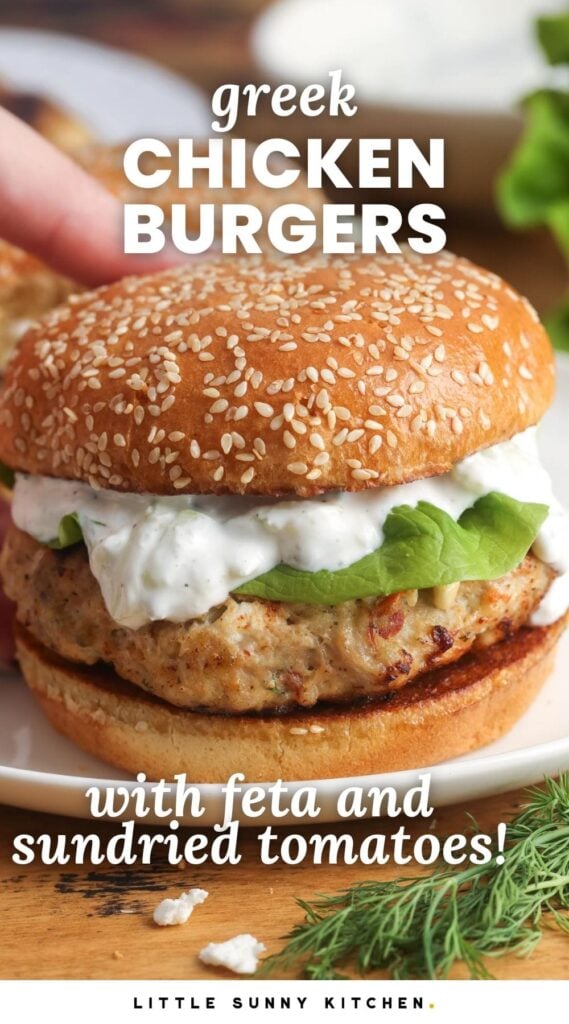 a chicken burger topped with tzatziki sauce on a sesame seed bun. Text overlay says "greek chicken burgers"