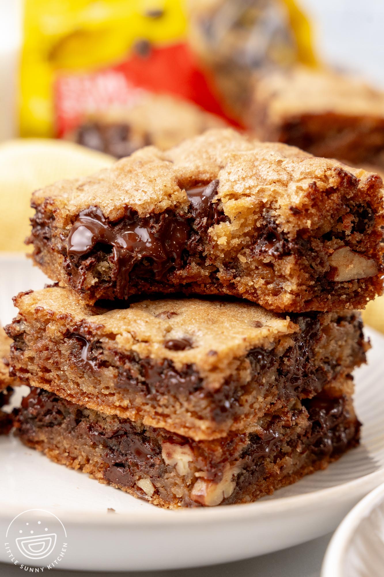 a stack of three toll house cookie bars. The top one has a bite taken.