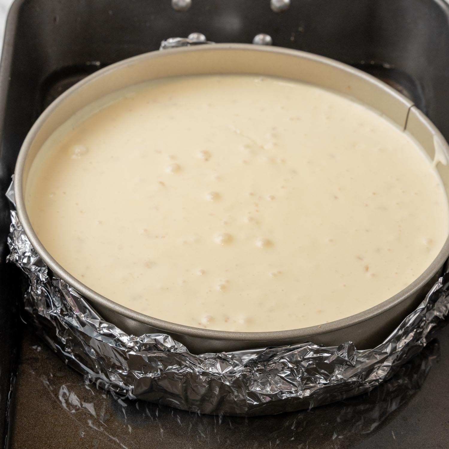 banana pudding cheesecake cooking in a water bath.