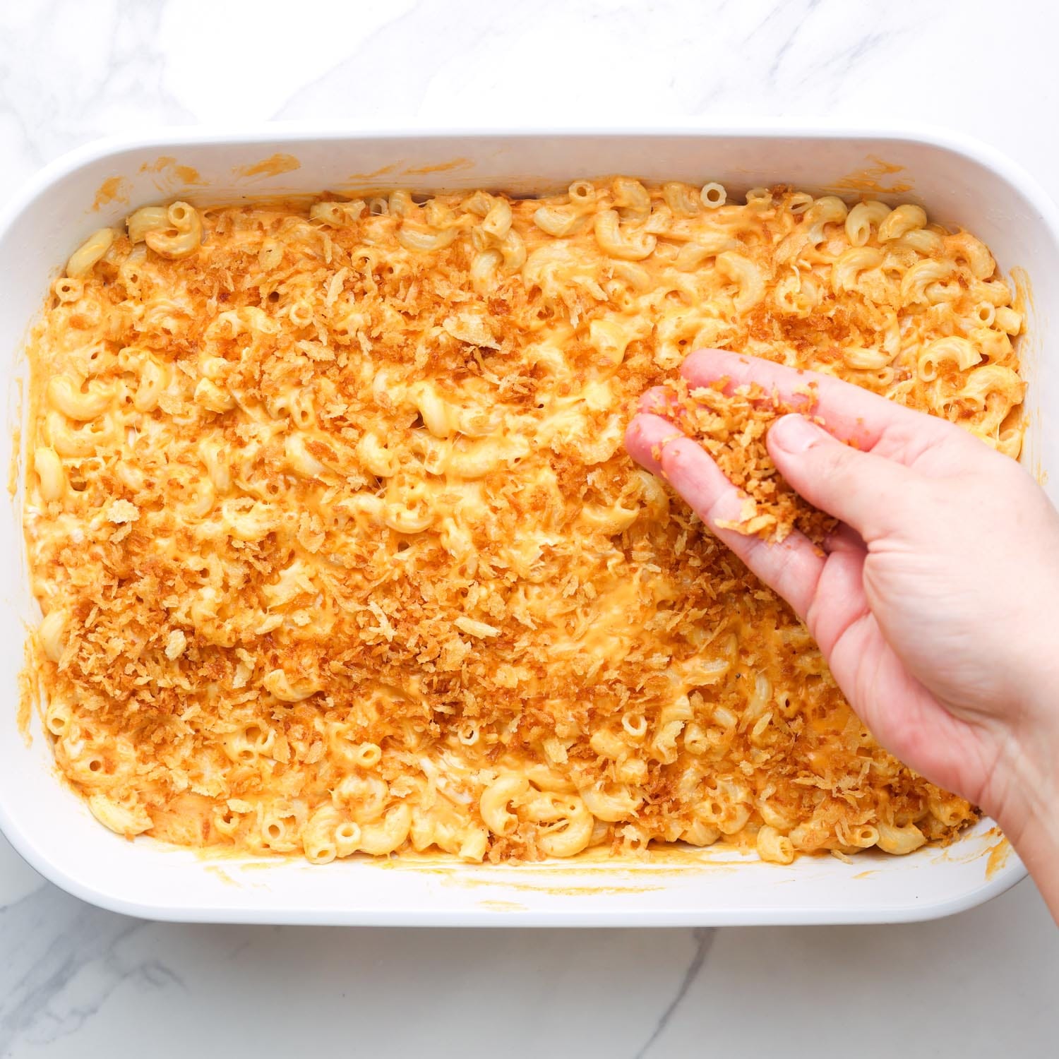 crispy panko bread crumbs added to the top of a pan of buffalo macaroni and cheese.