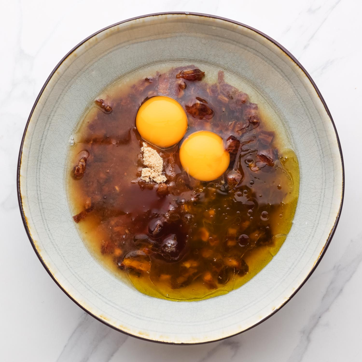 dates soaking in boiled water. Eggs and sugar are added to the mixture.