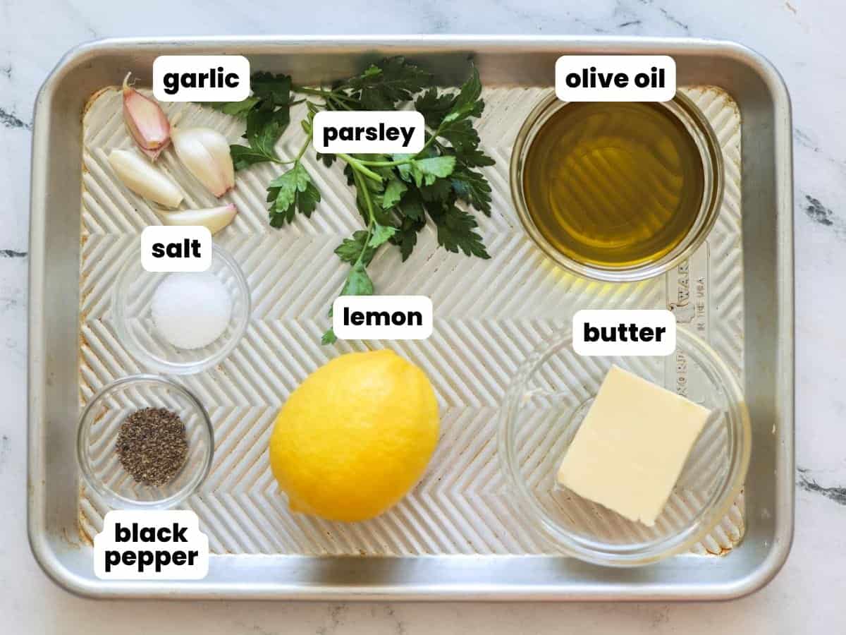 Ingredients for amogio sauce for spiedini, measured into small bowls, arranged on a metal tray.