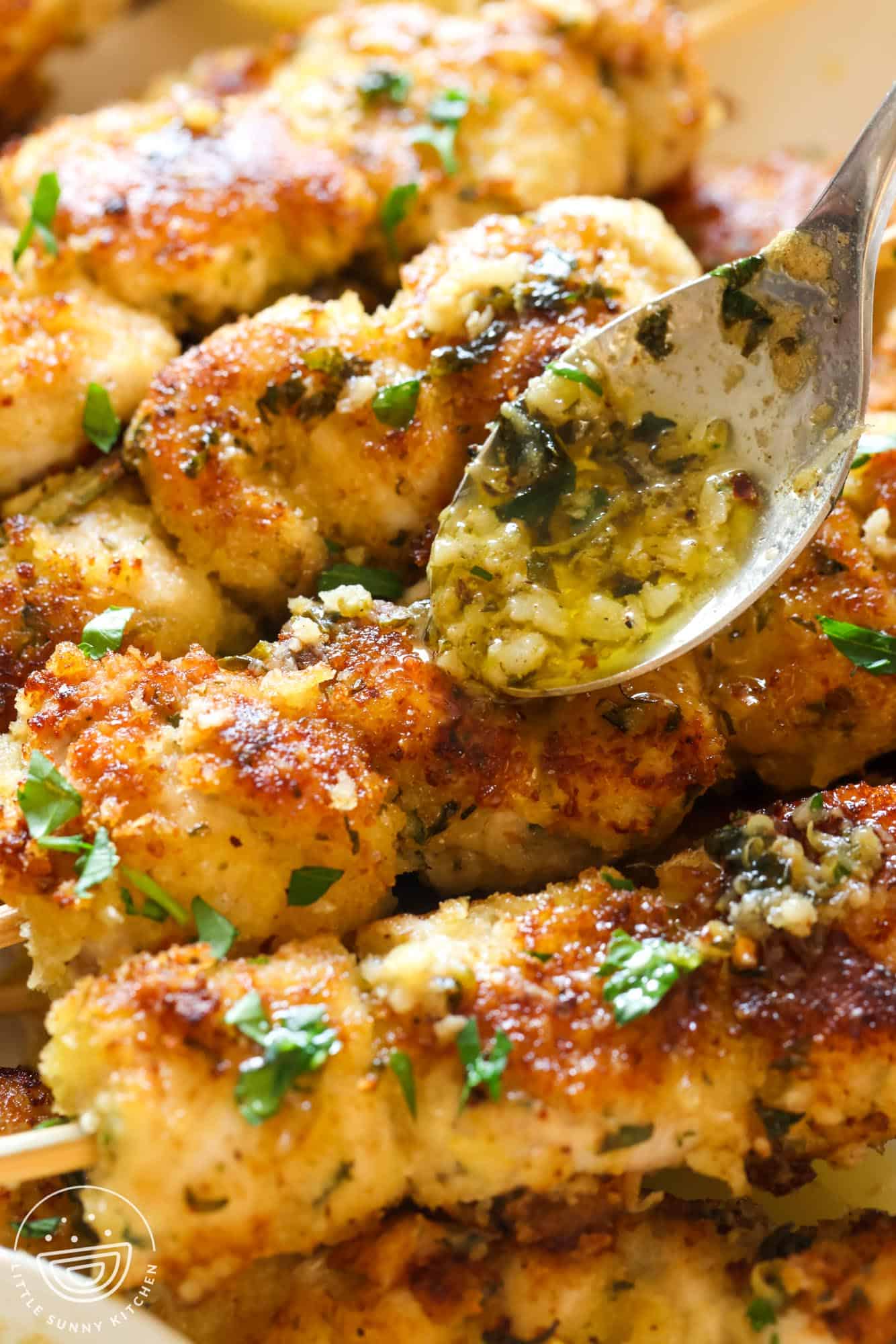 garlic butter amogio sauce spooned over crispy chicken spiedini skewers.