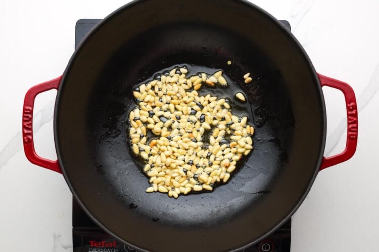 pine nuts toasting in a skillet.