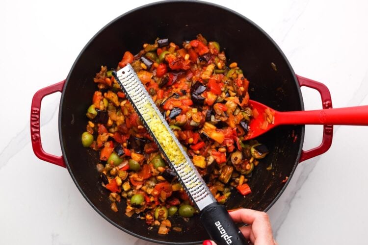 lemon zest on a microplane grater added to warm caponata.