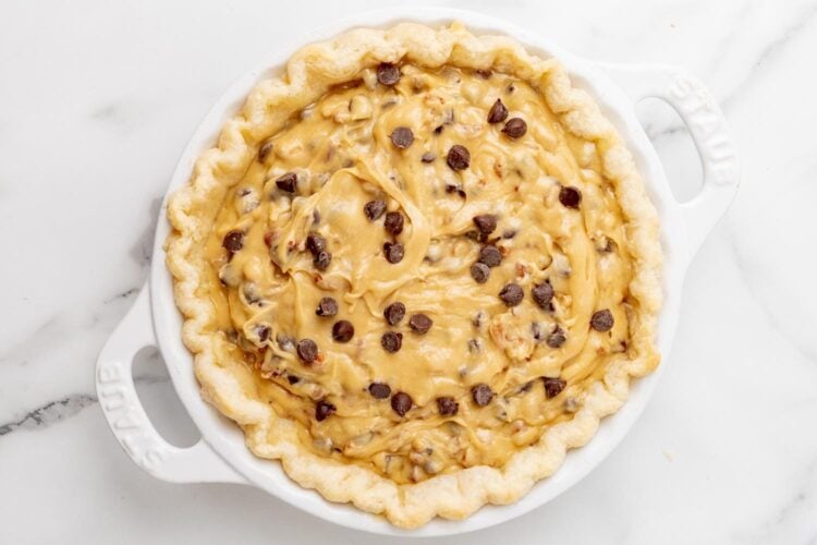 a par baked pie crust filled with chocolate chip cookie filling and topped with extra chocolate chips.