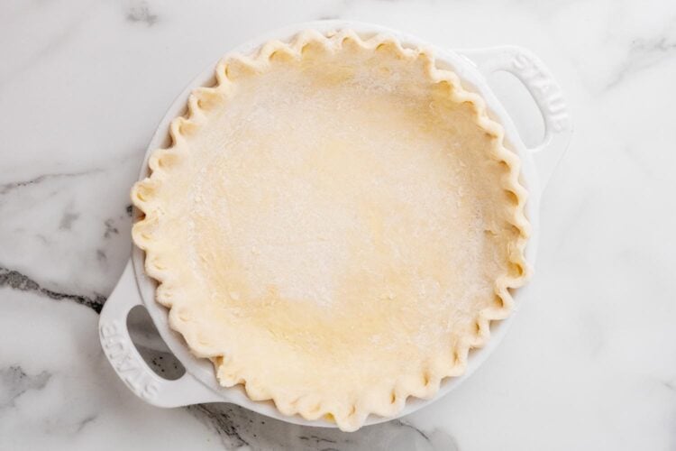 pie crust in a pie pan with crimped edges.