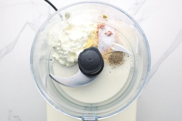 cottage cheese and seasonings in the bowl of a food processor.