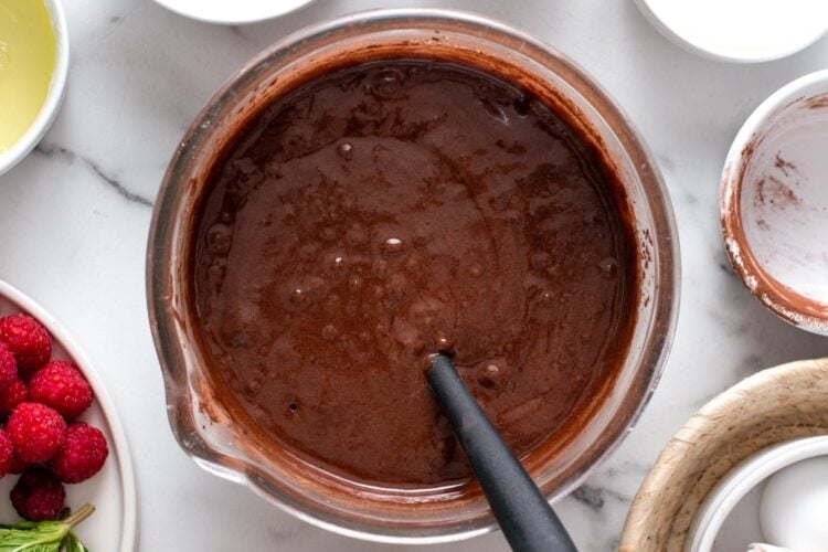 chocolate cake batter mixture in a glass bowl, viewed from overhead.