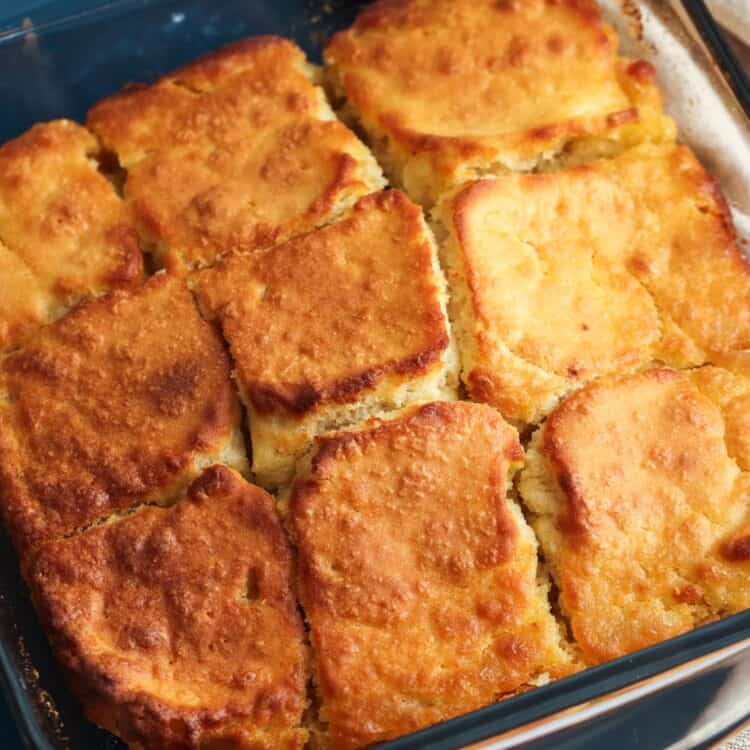 a square glass pan of butter swim biscuits cut into 9 servings.
